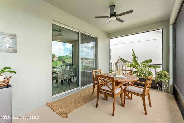 sunroom featuring a ceiling fan