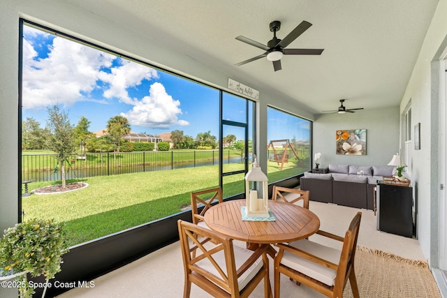 sunroom / solarium featuring ceiling fan