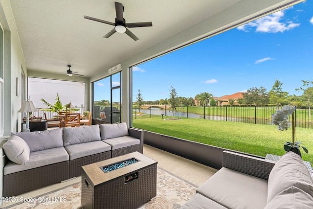 sunroom with a water view and a ceiling fan