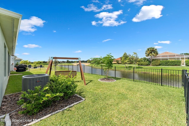 view of yard with a playground, a fenced backyard, and central air condition unit