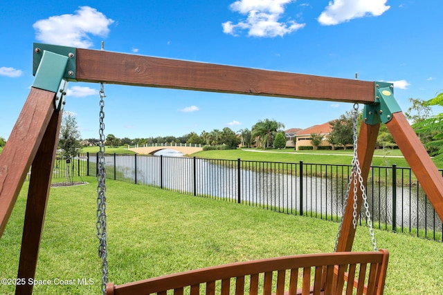 view of yard with a water view and fence