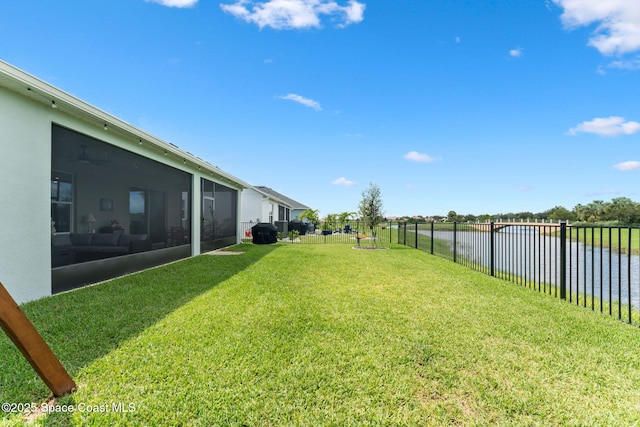 view of yard featuring a sunroom and a fenced backyard