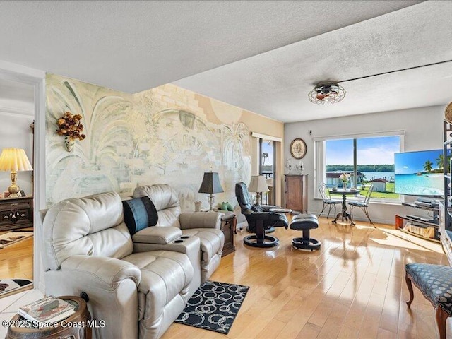 living area with a textured ceiling and wood finished floors