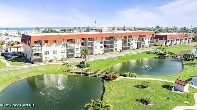 birds eye view of property with a water view