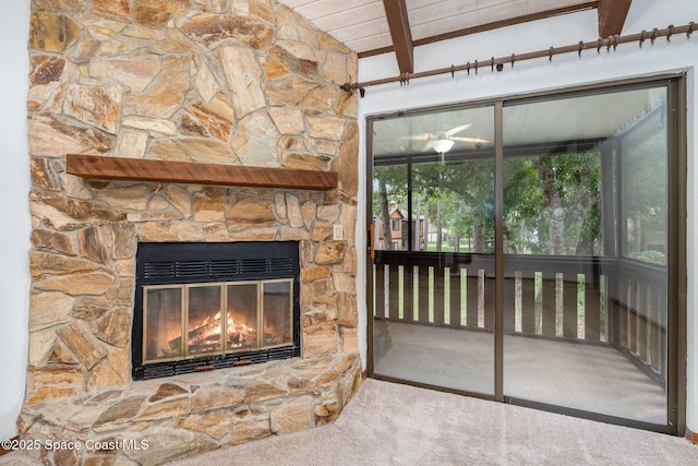 interior space featuring beamed ceiling and a fireplace