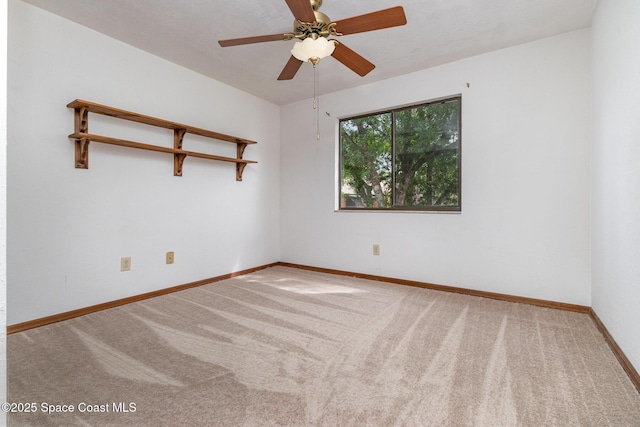 unfurnished room featuring carpet floors, baseboards, and a ceiling fan