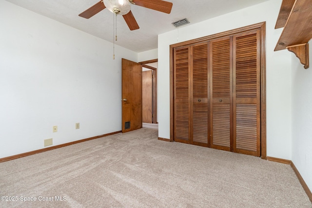 unfurnished bedroom with visible vents, baseboards, ceiling fan, carpet floors, and a closet