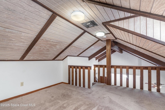 additional living space with carpet floors, vaulted ceiling with beams, visible vents, wood ceiling, and baseboards