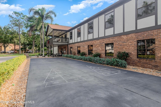 view of property's community featuring shuffleboard