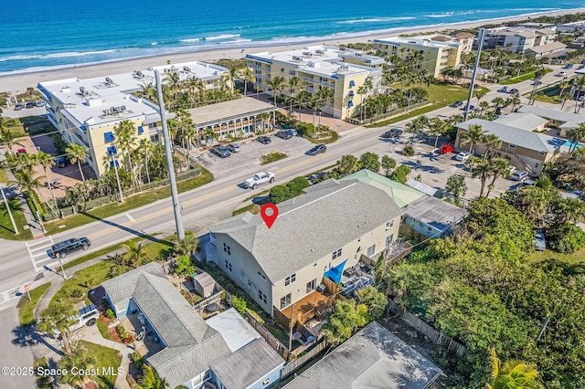 drone / aerial view featuring a view of the beach and a water view