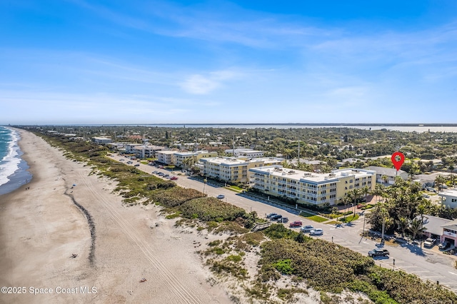 bird's eye view featuring a water view and a view of the beach