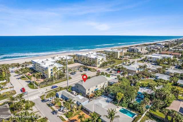 drone / aerial view with a water view and a view of the beach