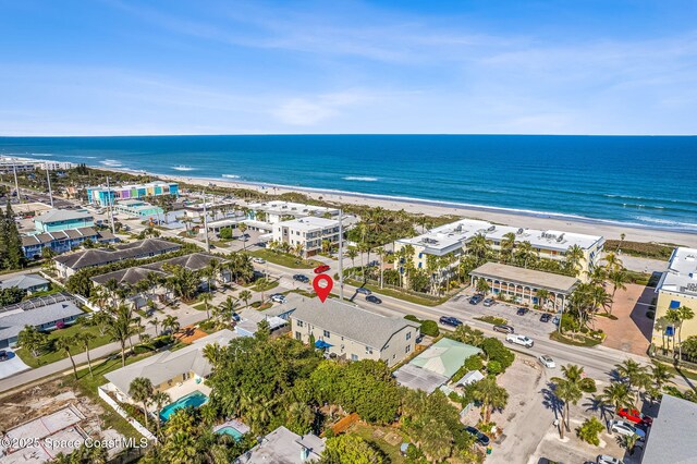 birds eye view of property with a beach view and a water view