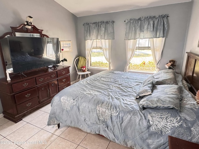 bedroom featuring lofted ceiling and light tile patterned floors