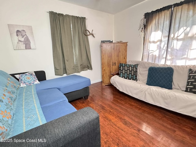 living area featuring wood finished floors and baseboards