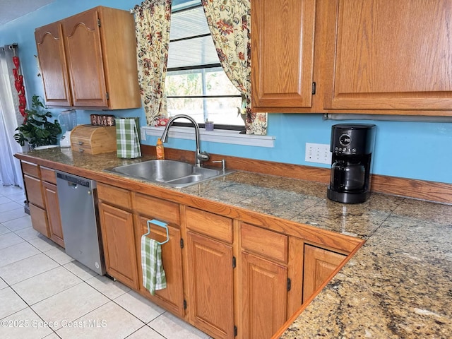 kitchen featuring dishwasher, tile countertops, brown cabinets, a sink, and light tile patterned flooring