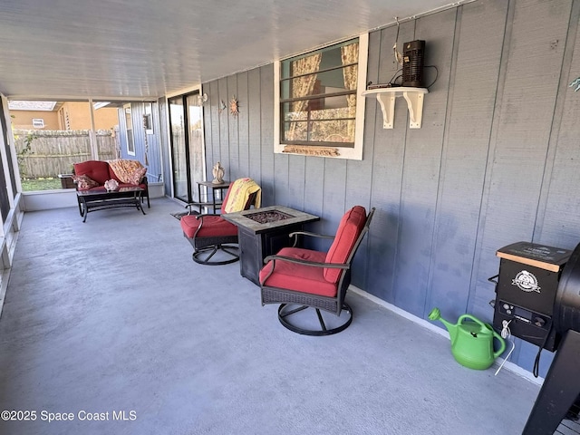 view of patio with a porch, an outdoor fire pit, and fence