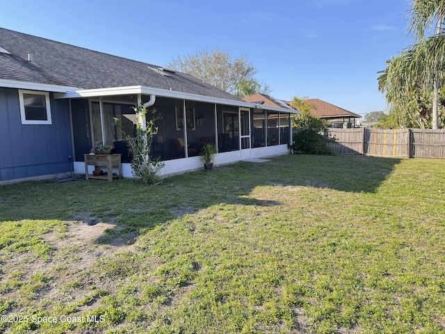 view of yard featuring fence and a sunroom