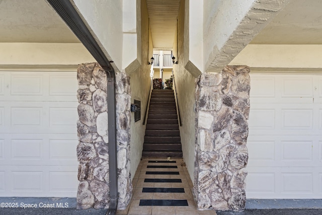 stairway featuring tile patterned flooring