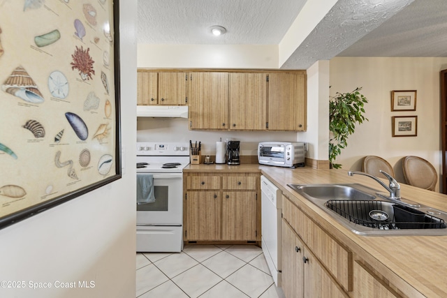 kitchen with light countertops, a sink, a textured ceiling, white appliances, and under cabinet range hood