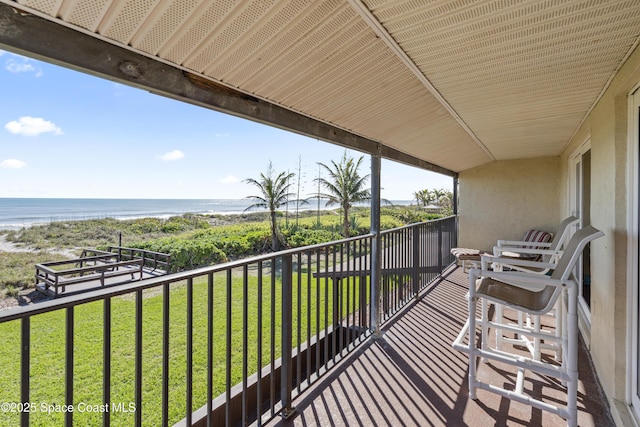 balcony featuring a water view and a beach view