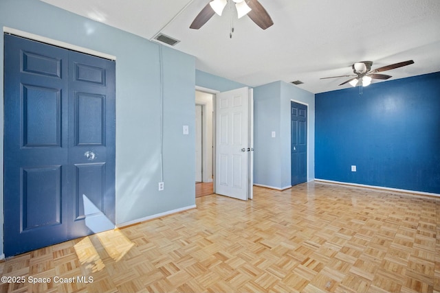 spare room with visible vents, ceiling fan, and baseboards