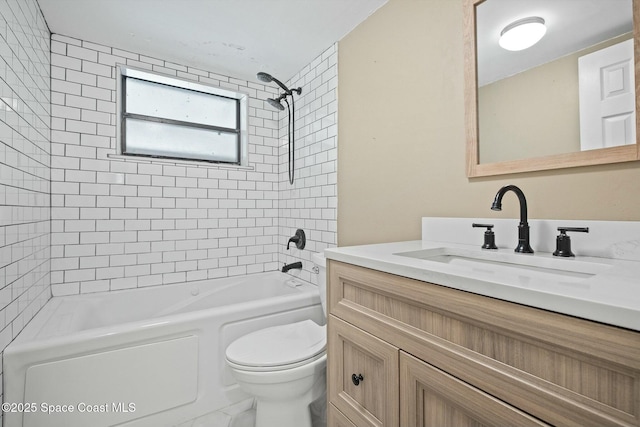 bathroom featuring toilet, vanity, and shower / bathing tub combination