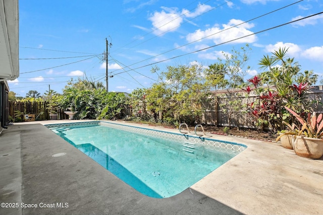 view of pool featuring a patio, a fenced backyard, and a fenced in pool