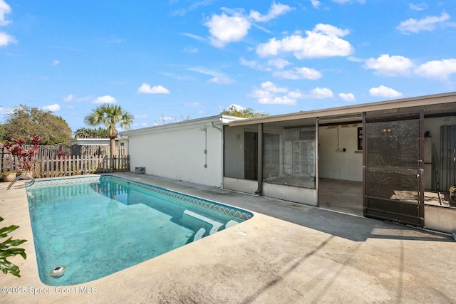 view of swimming pool featuring fence, a fenced in pool, and a patio