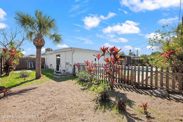 exterior space with fence private yard and stucco siding