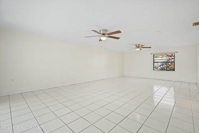 spare room with a ceiling fan, visible vents, baseboards, and light tile patterned floors