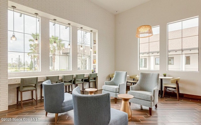 sitting room with baseboards and wood tiled floor