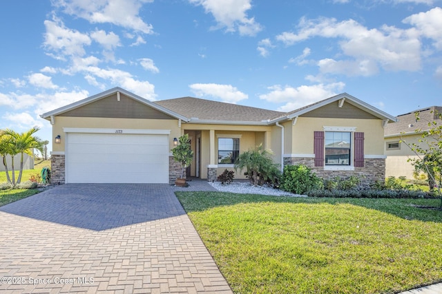 view of front of house featuring a front yard, stucco siding, decorative driveway, a garage, and stone siding