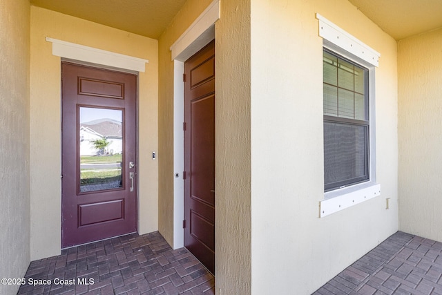 property entrance featuring stucco siding