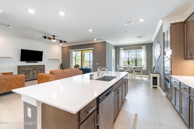 kitchen with visible vents, crown molding, light countertops, stainless steel appliances, and a sink