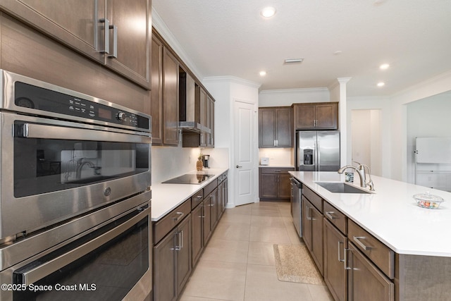 kitchen featuring visible vents, a sink, stainless steel appliances, light countertops, and crown molding