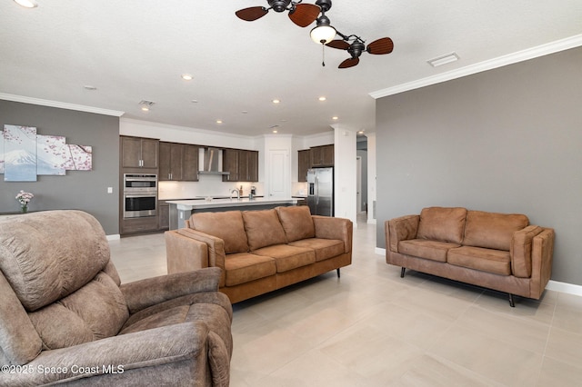 living room with crown molding, recessed lighting, baseboards, and ceiling fan