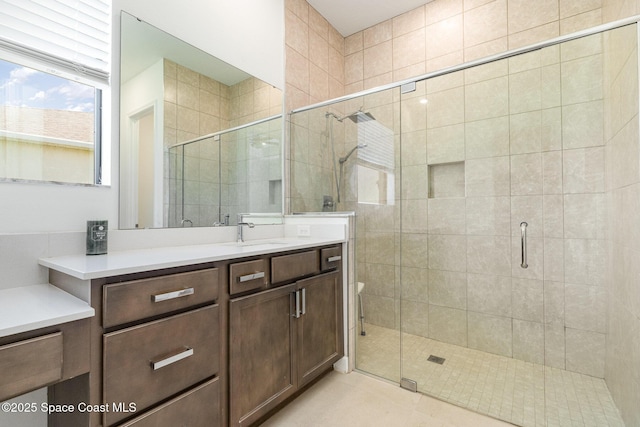 full bathroom with vanity and a shower stall