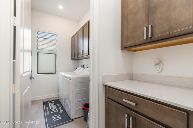 clothes washing area with recessed lighting, cabinet space, washer and dryer, and baseboards