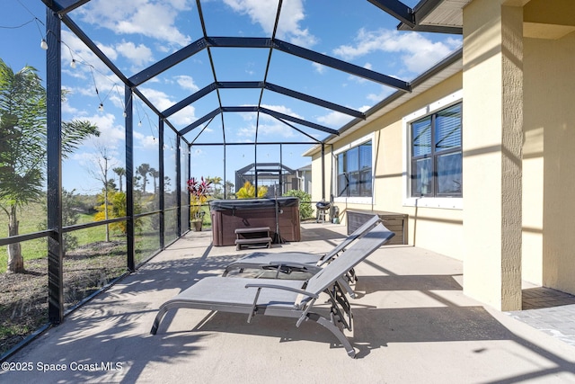 view of patio with a lanai and a hot tub