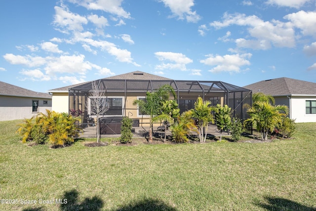 back of house featuring stucco siding, a lawn, and a lanai