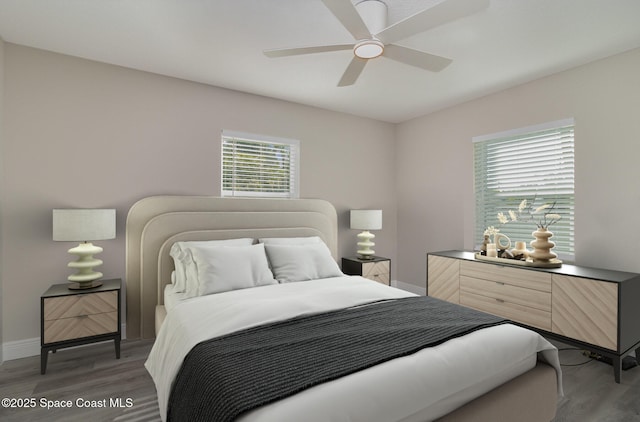 bedroom featuring light wood-style floors, ceiling fan, and baseboards