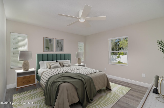 bedroom featuring wood finished floors, a ceiling fan, and baseboards