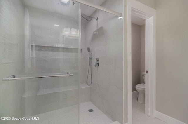 full bath with a shower stall, toilet, and baseboards