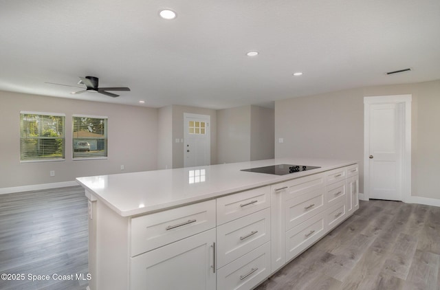 kitchen featuring light countertops, light wood-style flooring, visible vents, and baseboards