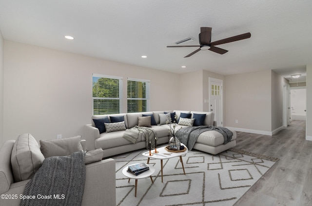 living room featuring recessed lighting, wood finished floors, a ceiling fan, visible vents, and baseboards