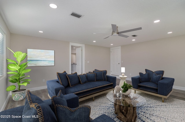 living area with visible vents, wood finished floors, and recessed lighting