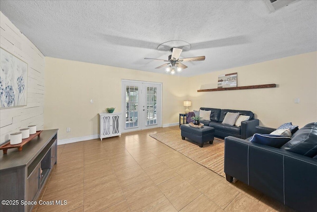 living area with baseboards, french doors, a textured ceiling, and ceiling fan