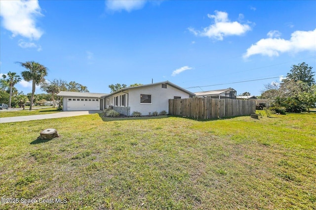 view of front facade featuring a front yard, fence, an attached garage, stucco siding, and concrete driveway