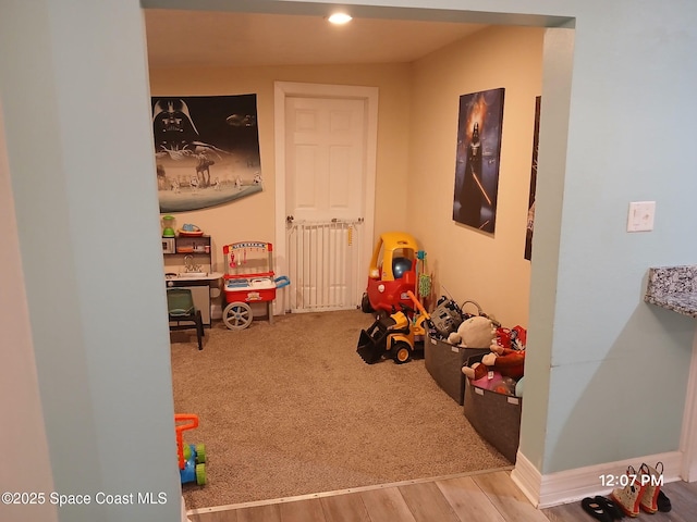 rec room with carpet, wood finished floors, and recessed lighting